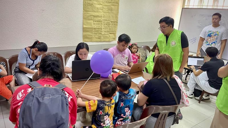 Children and parents register for a free health screening at the Makati East Philippines Stake Center